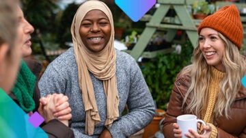 people smiling and laughing in winter clothes, and a woman with a coffee cup