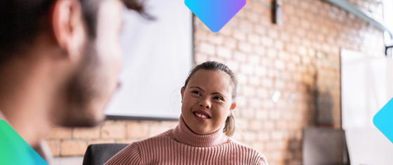 a woman with downs syndrome smiling speaking to someone else